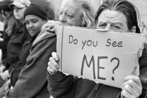 Man with sign Do you see me?